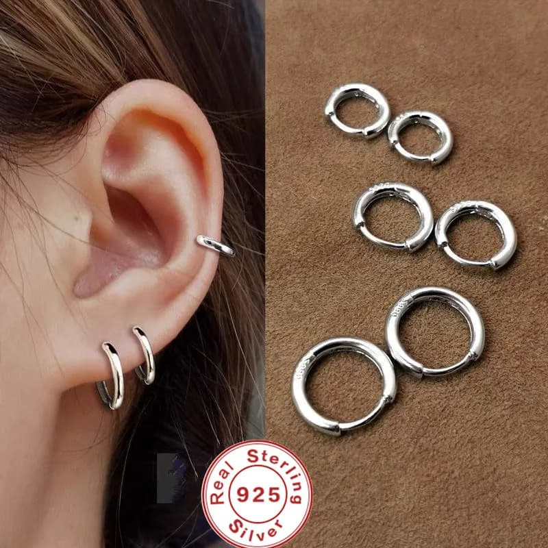 Small silver-tone stud earrings with white gem, pair view